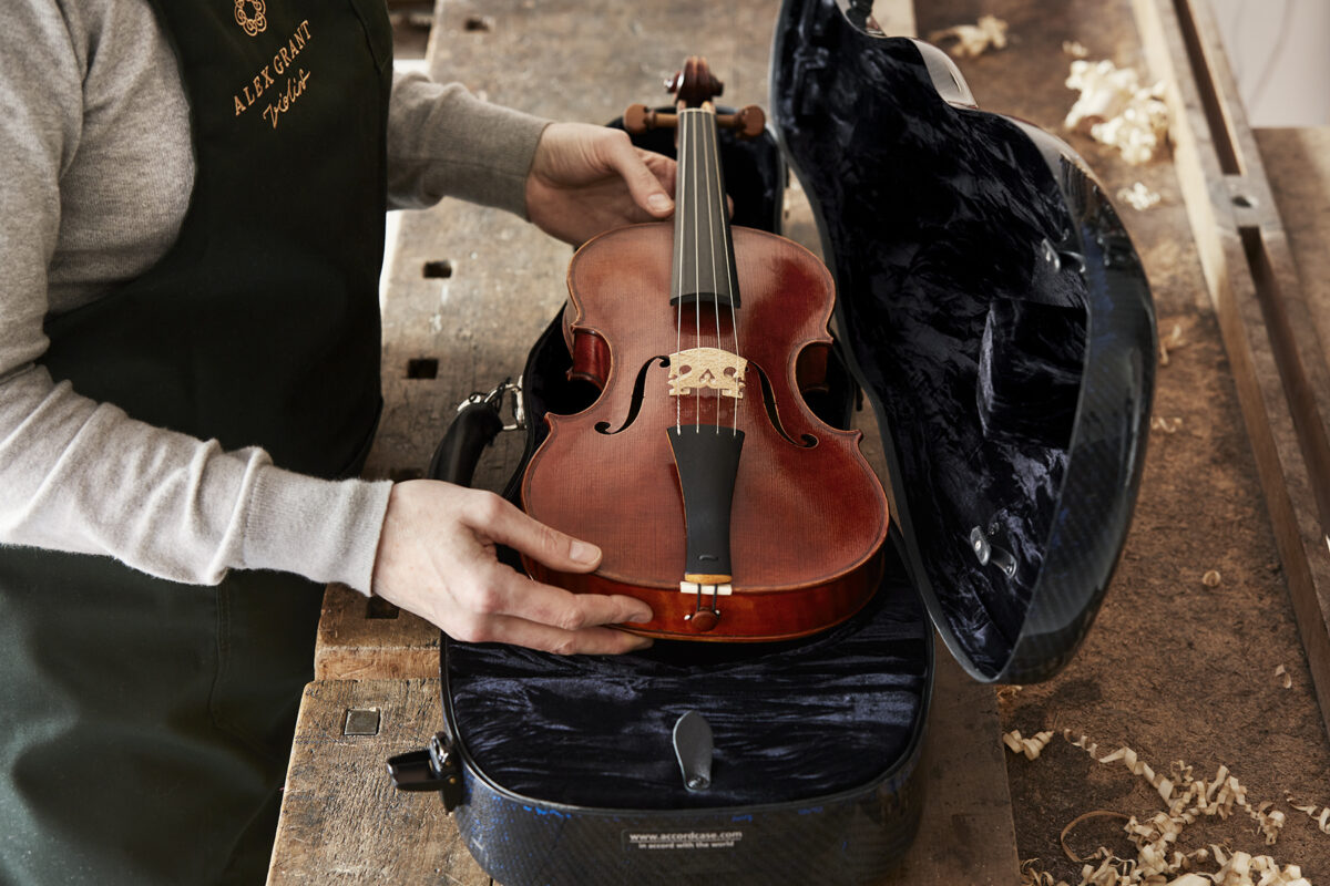 AGV Violin maker checks the fit of a Beilharxs Baroque Violin with its new case