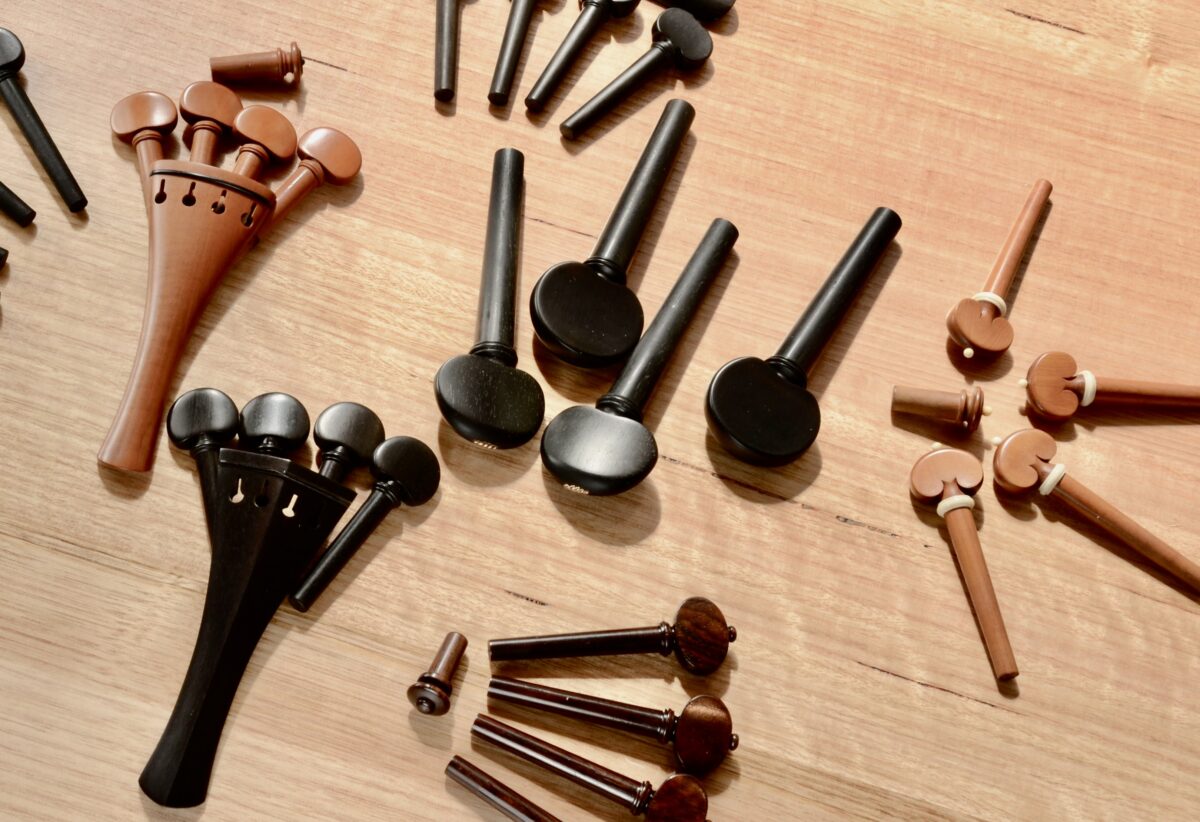 selection of fine tuning pegs, tailpieces, and buttons for violin, viola and cello in boxwood, ebony, and rosewood