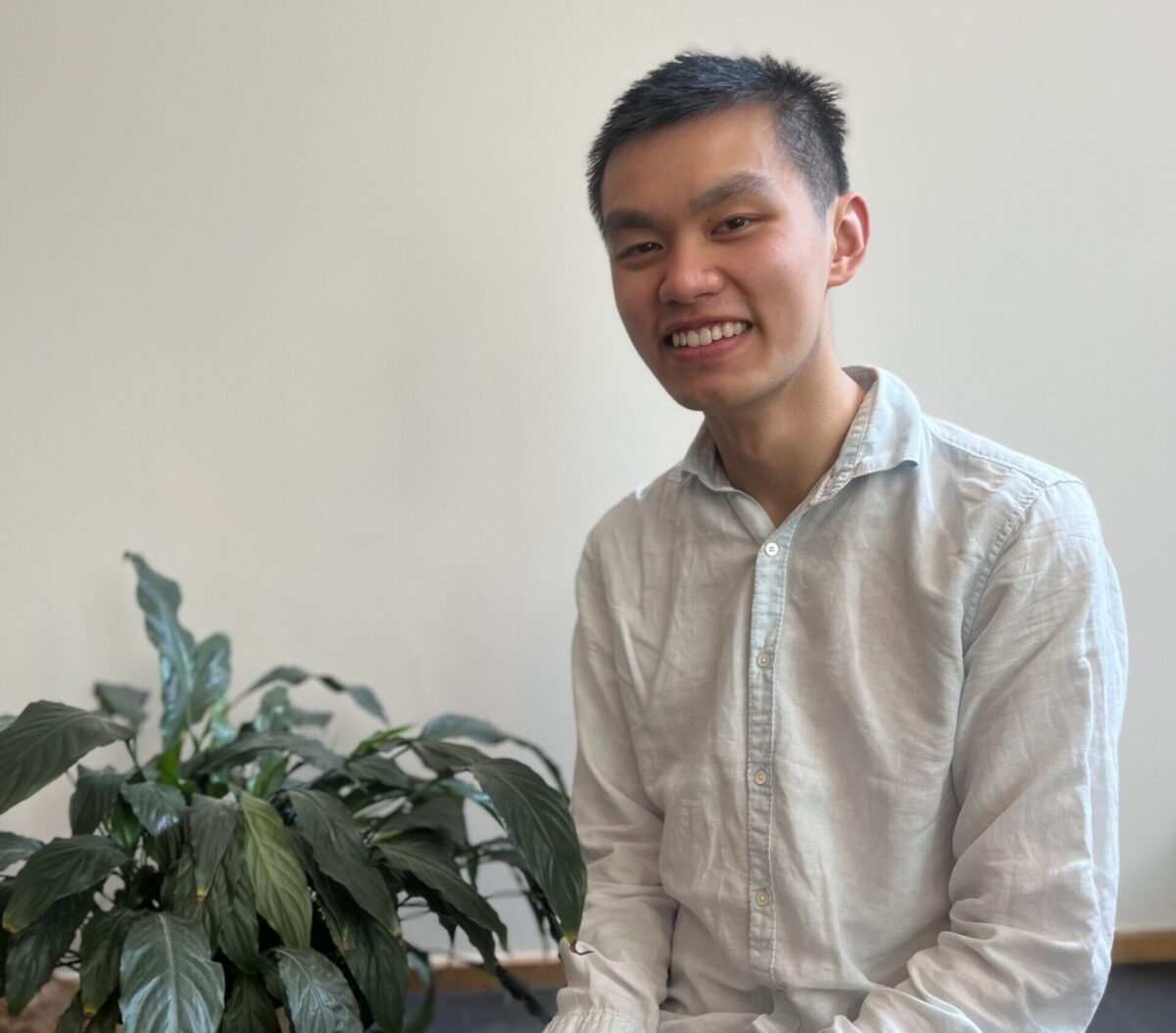 Staff member Tintin sitting by a plant. Ready to assist customers