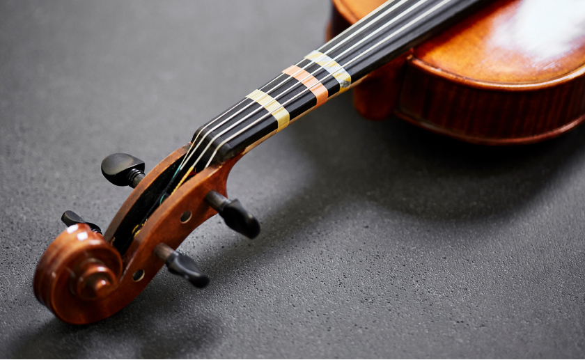 Beginner's violins, neck view with playing guide tapes